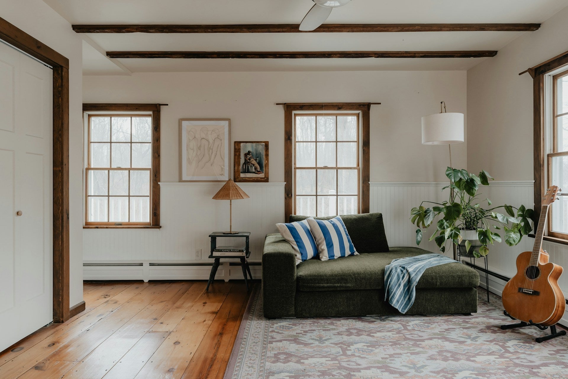 Collection of An 8x12 vintage rug in neutral and vibrant colors is central to the living room, enhancing its cozy and welcoming atmosphere. The room also features plush couch in a gallery layout