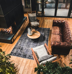 Collection of In the middle of the cozy living room, bathed in warm sunlight filtering through the window, is a nice 7x10 area rug. The cozy furniture placed around the rug c in a gallery layout