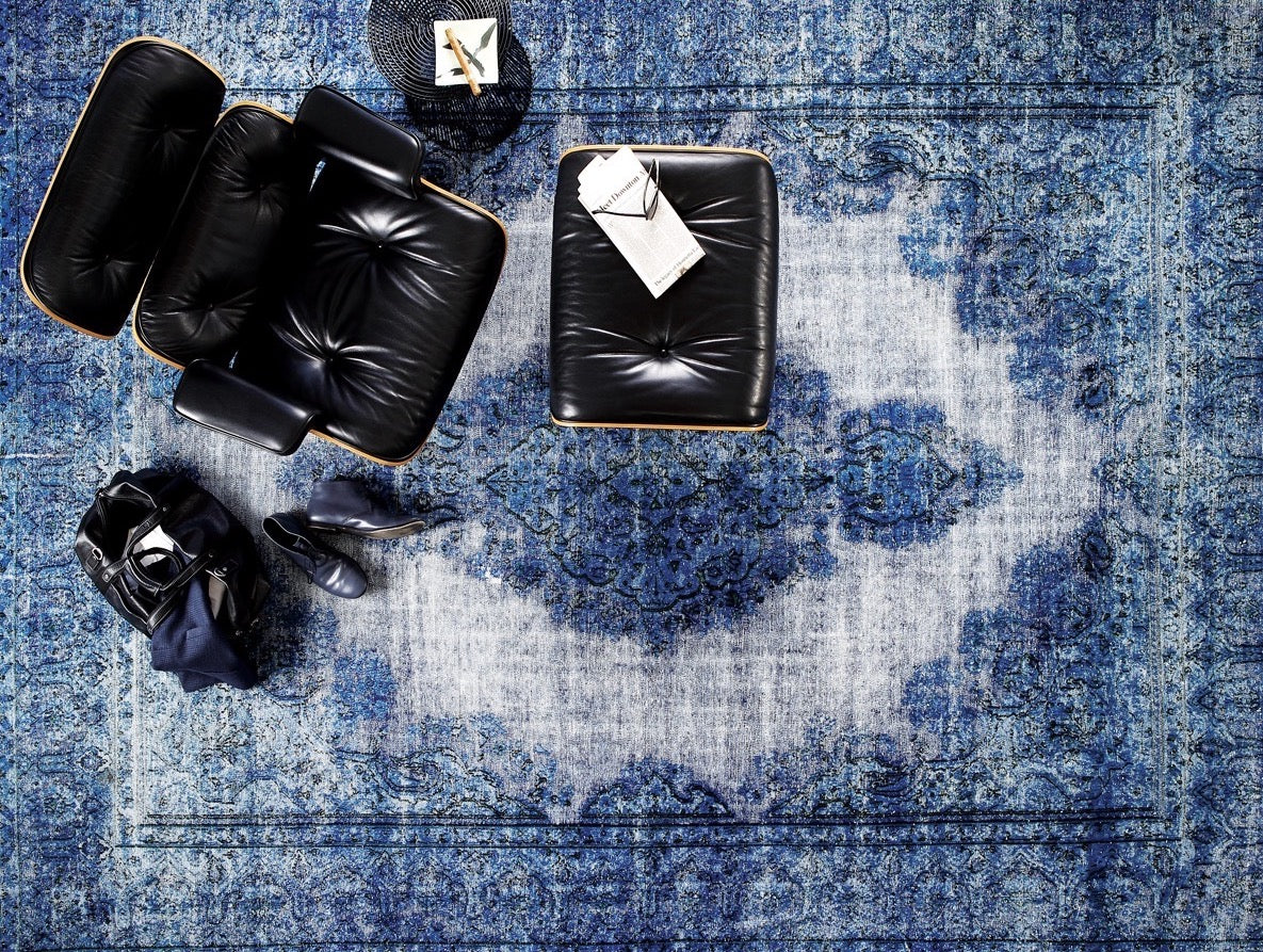 Collection of The living room boasts a stylish vintage area rug in blue tones, elegantly positioned with comfortable yet sophisticated furniture. From this bird's eye view, t in a gallery layout