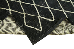 Collection of 5' 5'' x 7' 9'' Black Color Moroccan Rug in a gallery layout